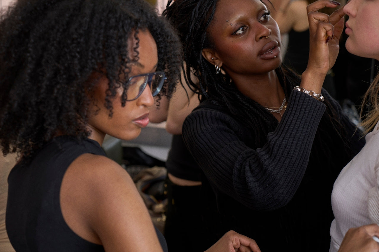 artists backstage working on each other's looks, craft in motion